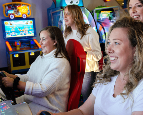 Girls playing racing games at Arcade alley in Bowlarama.
